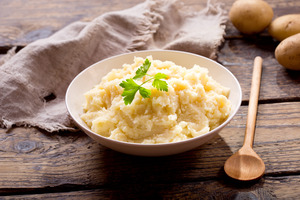 Bowl of mashed potatoes with a garnish