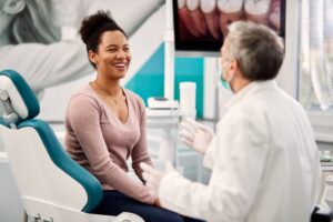 Woman asking questions during her dental implant consultation
